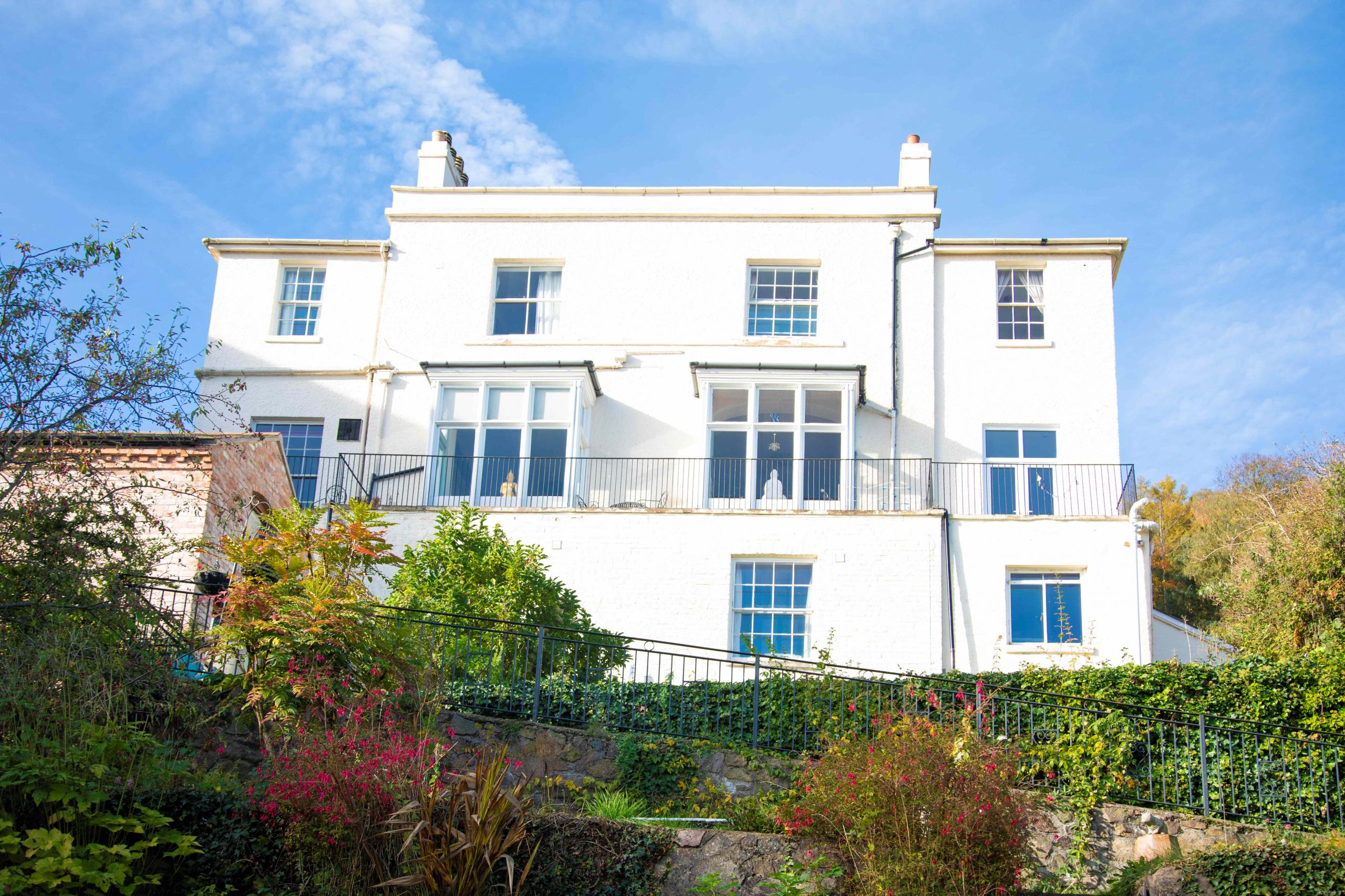 a white building above a garden 